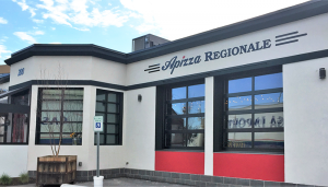 Façade of Apizza Regionale, across the street from Dinosaur Bar-B-Que in Syracuse. The restaurant opened in March and features a patio outside.