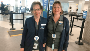 Diana Wolpert (left) and Debbie Trepanier volunteer at Syracuse Hancock International Airport as fly guide ambassadors.
