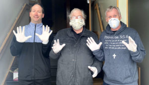 Deacon Don Harter, pastor Monte Smith and deacon James Jace of North Syracuse Christian Church perform at religious ceremony.