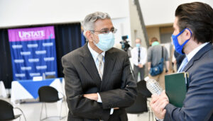 SUNY Upstate Medical University President Mantosh Dewan, MD, speaks with SUNY Chancellor Jim Malatras, right, during one of the chancellor’s visits to the Upstate campus last fall. Photo provided
