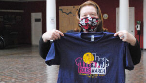 CNY Folksmarch’s vice president Sue Straub shows off the group’s new T-shirt.