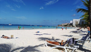 Located on the Mexico’s Yucatan Peninsula bordering the Caribbean Sea, Cancun is known for its wonderful beaches and fun in the sun. Cancun was built specifically to lure tourists to what, in 1970, was a remote area of Mexico. The area was perfect due to year-round good weather, blue skies, white sand beaches lined with palm trees, few mosquitos and snakes. Build it and they will come … and they have — in the millions. 1. Beaches: Most of the resorts have direct access to the beach. There’s a sandy beach (playa) perfect for everyone. Some beaches have more waves than others while some of the calmer ones may be best for those with small children. Not all beaches have flags indicating the safety level: green means it is safe for swimming while black means extreme danger. The beaches are found in several locations with the Cancun Hotel Zone claiming the best beaches. Don’t forget the sun screen. 2. Maya Museums: Learn about the area’s rich culture from skeletal remains that date back 14,000 years to modern day including displays of Mayan architecture and art. The museum was built in and around the San Miguelito archeological site, providing a look into Mayan civilization and pre-Columbian culture. Don’t miss the underwater museum with dozens of statues that can be enjoyed by diving or on a glass-bottom boat. There is an eco-aspect to the exhibit. The marine cement promotes reef growth and water fauna. 3. Xcaret: Xcaret is a unique theme park where it is easy to spend the entire day. Visitors can snorkel through an underground river, visit a coral reef aquarium with a sea turtle center, learn about Maya culture at the folk museum, and enjoy water activities on the beach and lagoon. Not to miss is the Mexico Espectacular, a colorful evening extravaganza covering many aspects of Mexican history. 4. Isla Mujeres: Isla Mujeres, The Island of Women, is a 20-minute ferry ride from Cancun. While it is touted as a quiet getaway, there are several things to do. Rent a golf cart and drive to Punta Sur at the island’s southernmost tip where an ancient temple honors the Mayan moon goddess. Garrafon Reef Park offers a variety of things to do including snuba, a cross between snorkeling and scuba diving. 5. Chichen Itza: Even though it is a two-hour ride from Cancun it is the island’s most notable archeological site and is a UNESCO World Heritage site. It was the center of Mayan Civilization. El Castillo, the pyramid-like temple, honored the god Kukulkan. It is no longer permitted to climb the pyramid but there are many other things to see. In the evening there is a sound-and-light show. There are several hotels near the ruins, including The Lodge at Chichen Itza which offer a private entrance to the park. 6. Thrilling: There are many ways to get an adrenaline rush. Xplor, an all-inclusive adventure park, is the most visited zip-line park in the world. It has several other activities including exploring caves and underground rivers Explore the Rio Secreto Nature Reserve outside of Cancun where participants swim and wade in one of the most spectacular underground caves in Mexico. Try parasailing, jet skiing, diving in a cenote, ATV-ing through the jungle, and, the newest activity, fly-boarding. 7. Satisfy your appetite: Mexican cuisine is a mouthwatering mix of indigenous and Hispanic cultures. Enjoy spectacular sunsets and music along with a surf and turf meal on a romantic Spanish galleon dinner cruise. There are several cooking schools, including Yum Cooking Workshop where attendees can learn how to make traditional Mayan meals. It is the perfect family activity that includes tequila and mescal tasting. 8. Unique: Cancun is a popular destination for weddings but even people who are already wed can renew their vows with a traditional Mayan wedding performed by a shaman in the Mayan language. Try a temazcal, a sweat lodge of pre-Hispanic origins. It is overseen by a shaman who controls the heat by tossing water and herbs on the coals. It is supposed to improve health and healing by eliminating toxins, aiding in blood circulation, and toning the skin. It is usually included in a Mayan wedding ceremony but can be enjoyed any time. 9. Tips: Cancun is tourist-friendly and English is widely spoken in the tourist areas. Avoid the hassle of getting a taxi at the airport by preordering an airport-hotel transfer. Avoid booking tours and changing money at the airport. US dollars and credit cards are widely accepted. The best place to exchange money is at a bank and book tours recommended by your hotel. Remember it is customary to bargain when shopping. 10. Ruins: Chichen Itza is the most notable archeological site but Tulum is also popular. For an out-of-the-way archeological site inhabited by more iguanas than people check out the El Rey ruins. Playa del Carmen and the isle of Cozumel are also fun places to visit. The Sian Ka’an Biosphere is a UNESCO World Heritage Site near Tulum with an extensive canal system that weaves its way through the mangrove and it is home to a large number of migratory birds, reptiles, and marine life, many of which are on the endangered species list. Party lovers will have no trouble finding places to let loose. Many of the bars feature music in the evenings.