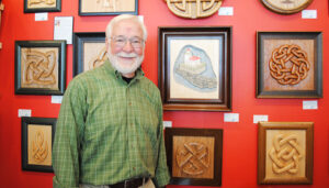 Carl Patrick, Oswego resident former director of nuclear communications for the New York Power Authority. “I wish I had known before I retired how many really interesting things there are to do,” he says. He is shown with his artwork, which is available at Riverside Artisans, an art co-operative in Oswego.