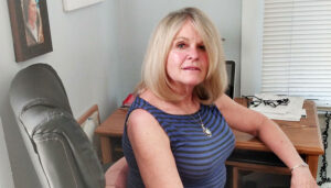 Donna Muhs-Mccarten in her home office. As a volunteer at ArtRage Gallery, she incorporates her love of art with her passion for social justice.