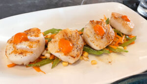 Four large diver sea scallops ($35) on a bed of slaw, featuring corn, snow peas and carrots. The quality of the entrée exceeded expectations.